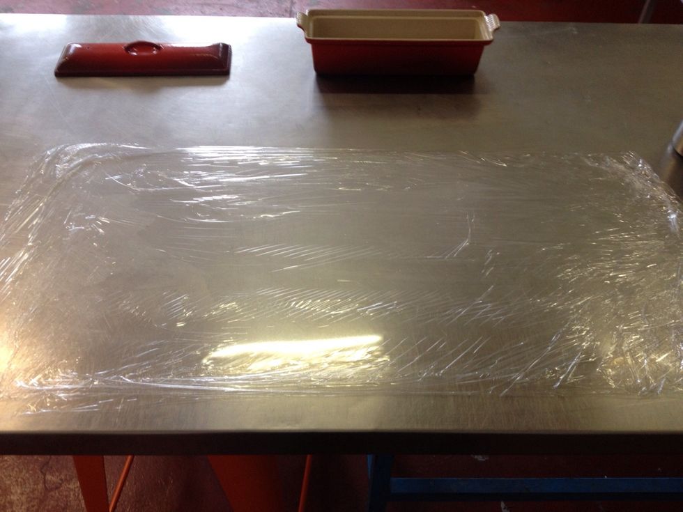 Roll out 3 layers of cling film and smooth out with a dry tea towel