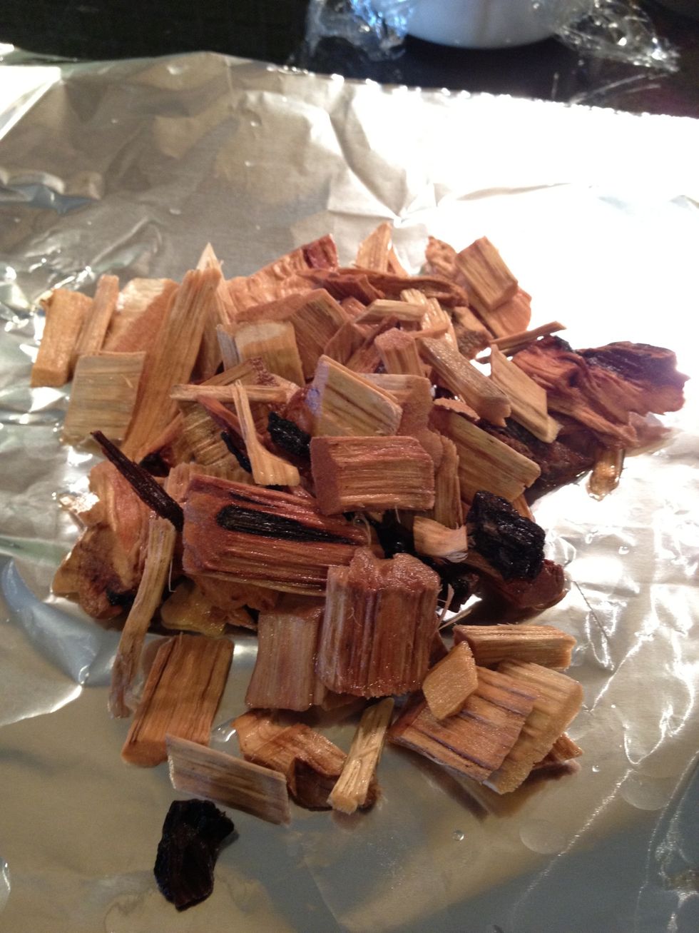 Roll out a large sheet of aluminum foil, take your wood chips out if the bowl of water and put them on the sheet.