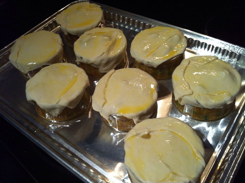 Roll out and cut puff pastry to fit over ramekins, brush with egg wash, bake at 400\u00b0F for 20 to 30 mins or until pastry is puffed and nicely browned