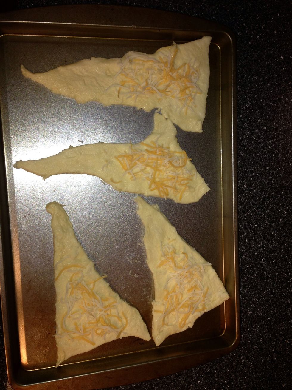 Roll out crescent rolls. Sprinkle a little cheese on top.