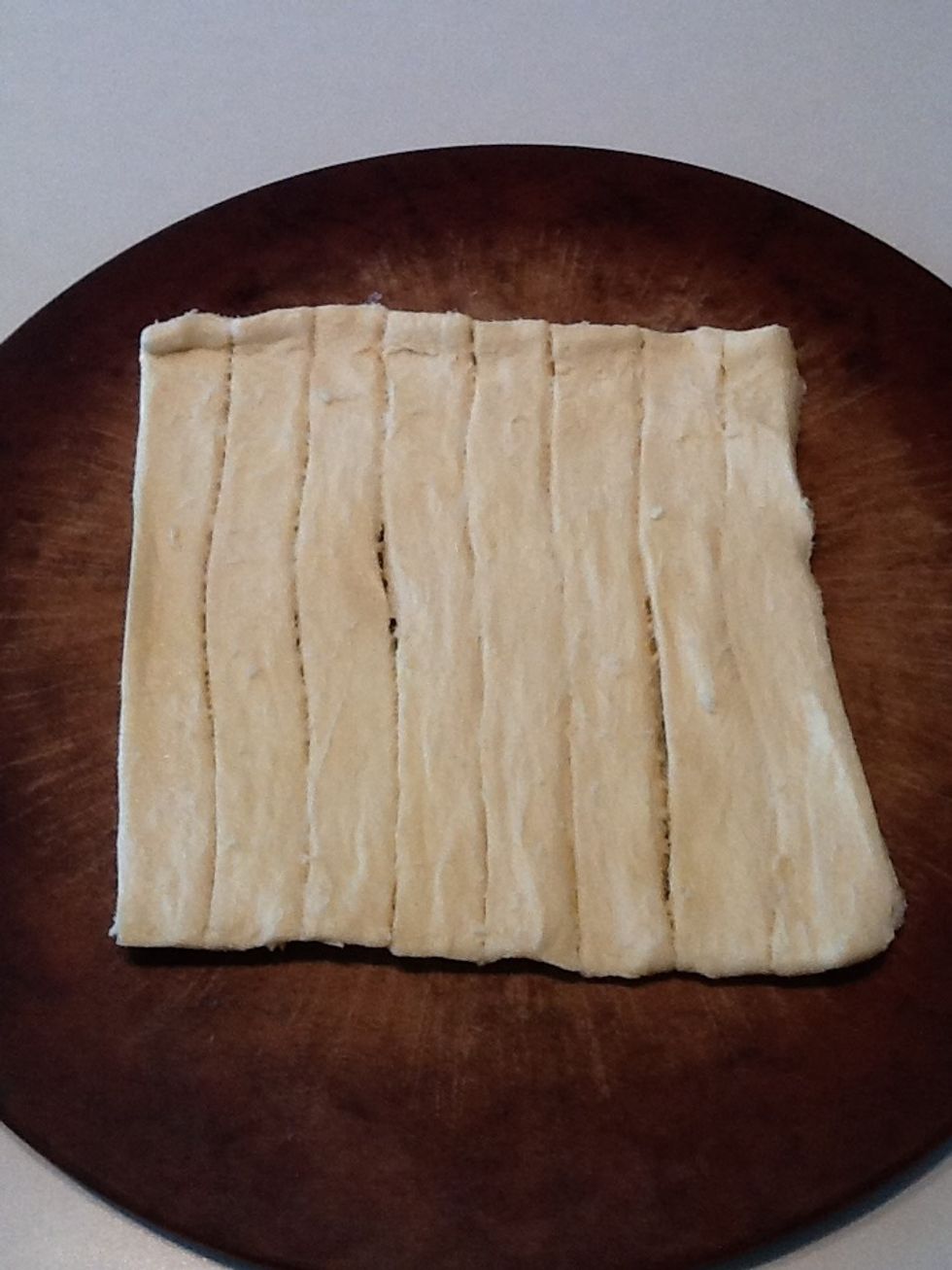 Roll out dough on baking pan.  I like Pillsbury Crescent Rounds because the dough is precut. If using a metal pan, you may want to spray with nonstick cooking spray before laying out the dough.