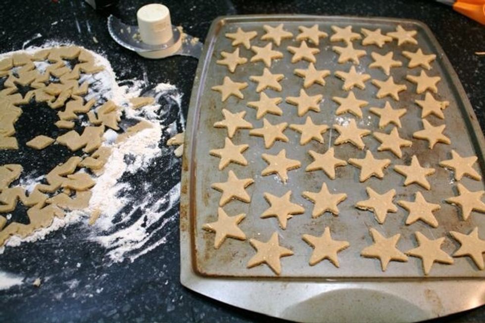 Roll out dough to 1/8 inch thick on a well floured surface. Using a small cookie cutter or glass, cut out crackers and place on an ungreased cookie sheet.