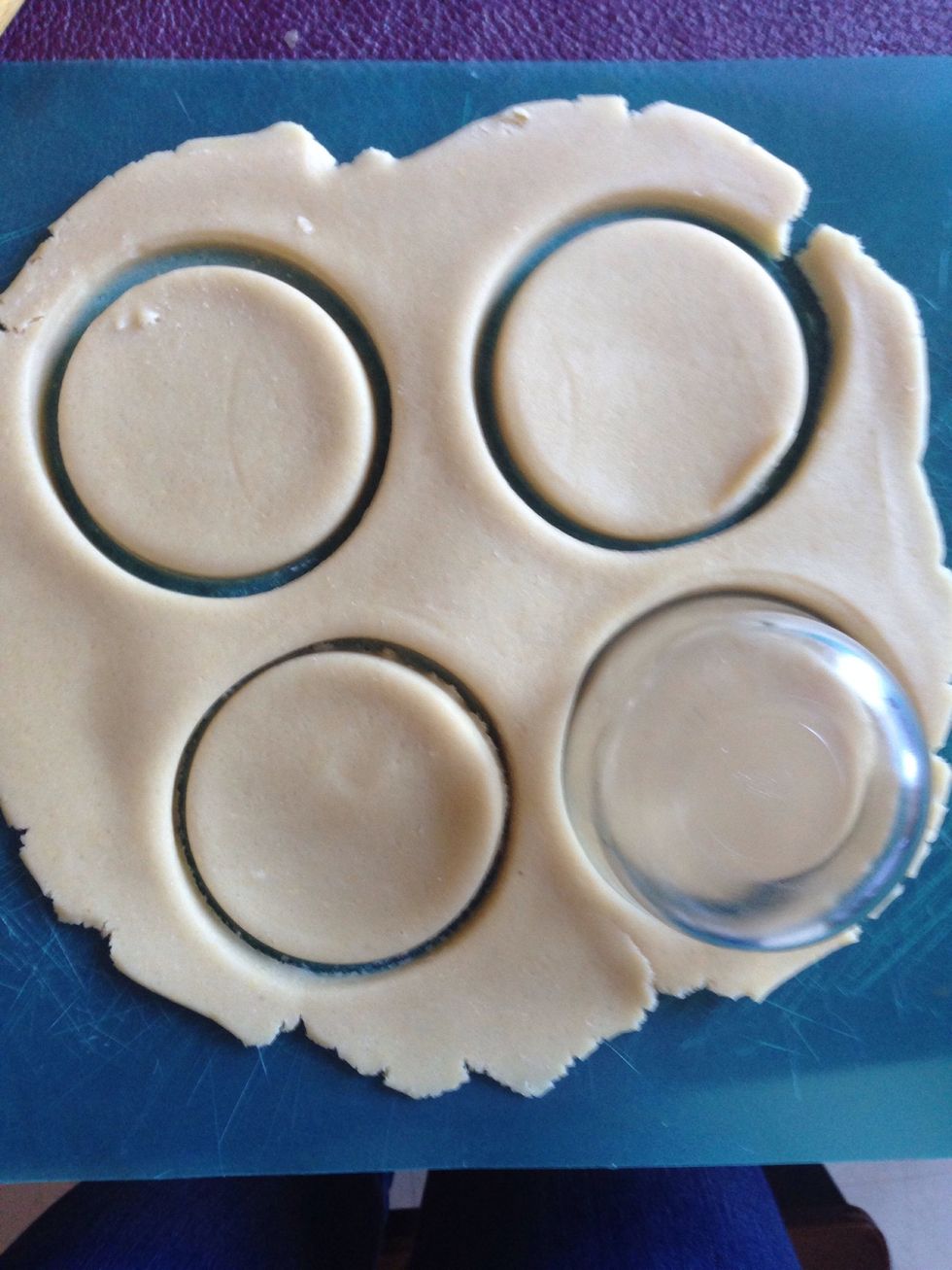 Roll out the dough and use a round glass to cut out the cookies