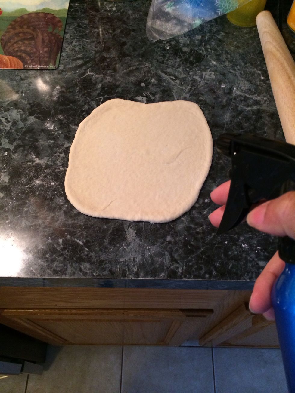 Roll out the dough as i showed you before, but this time spritz the top lightly with water. This will help the pita bread puff up.