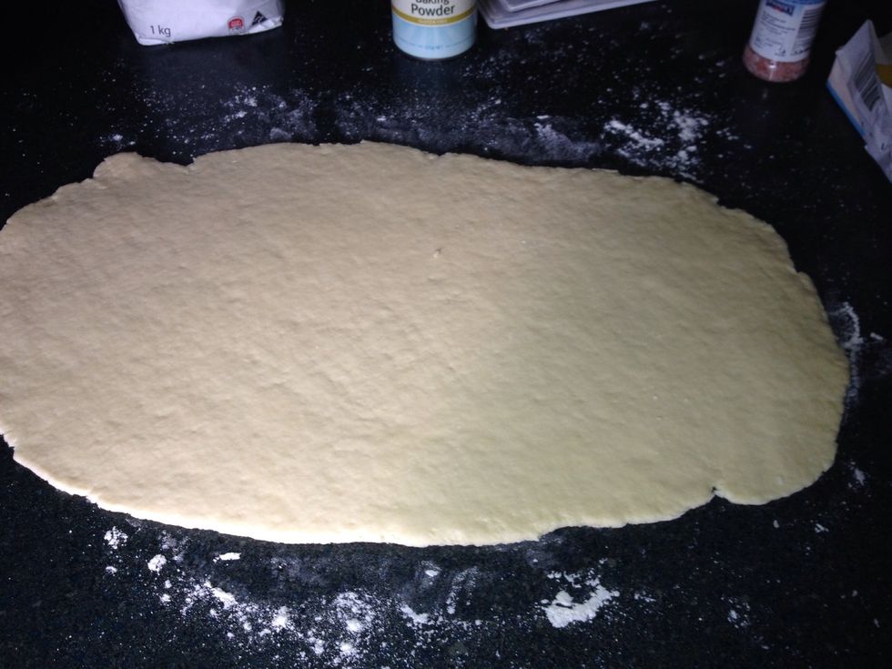 Roll out the dough until it is about 1cm thick and roughly rectangular.