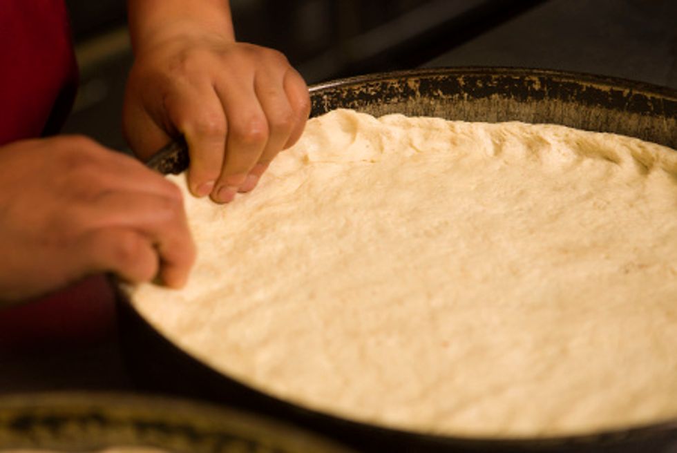 Roll out the dough with the rolling pin, make it thin but not to thin once your done curve the sides to make the crust.