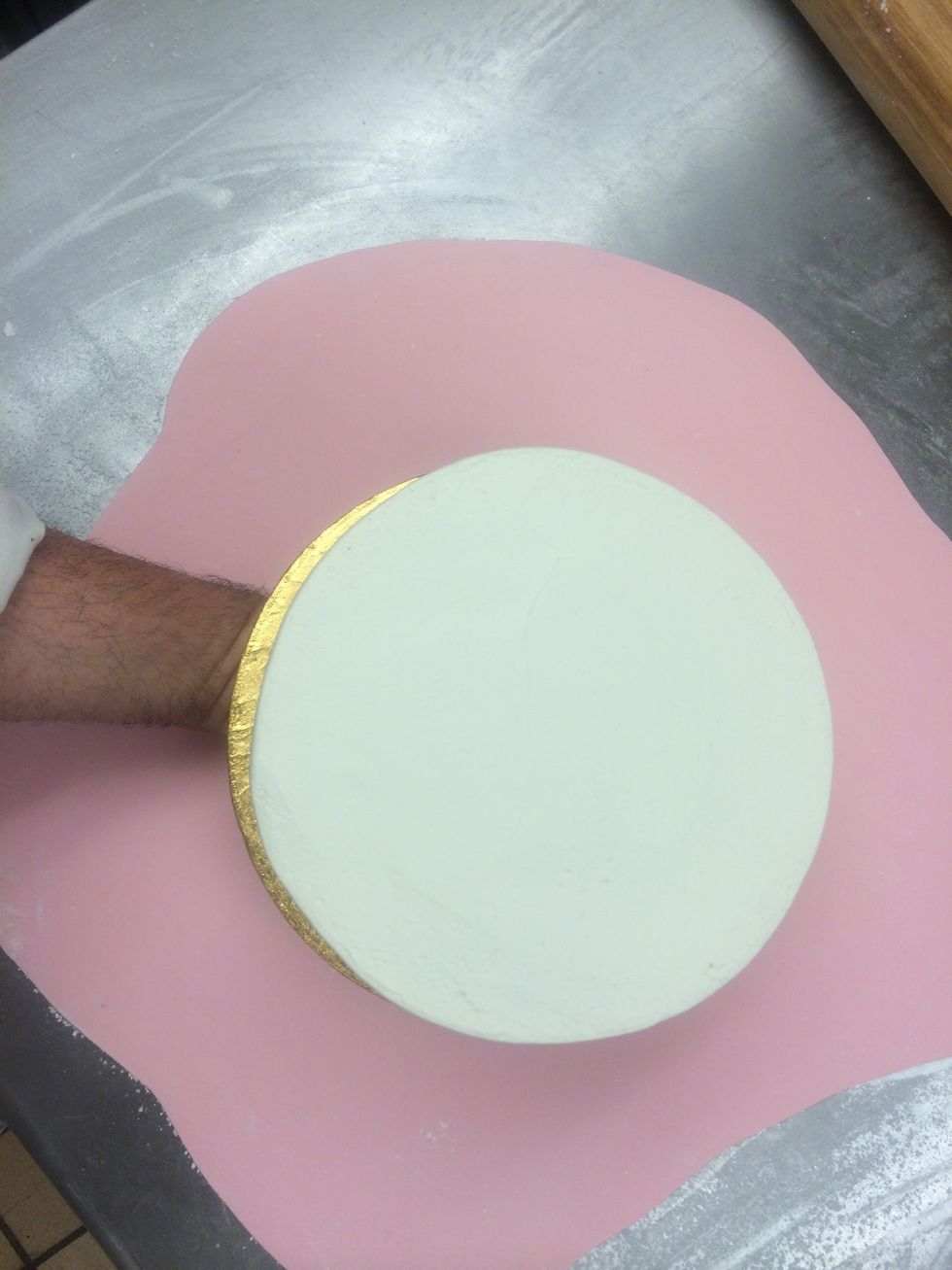 Roll out the fondant large enough to cover the cake and the board.