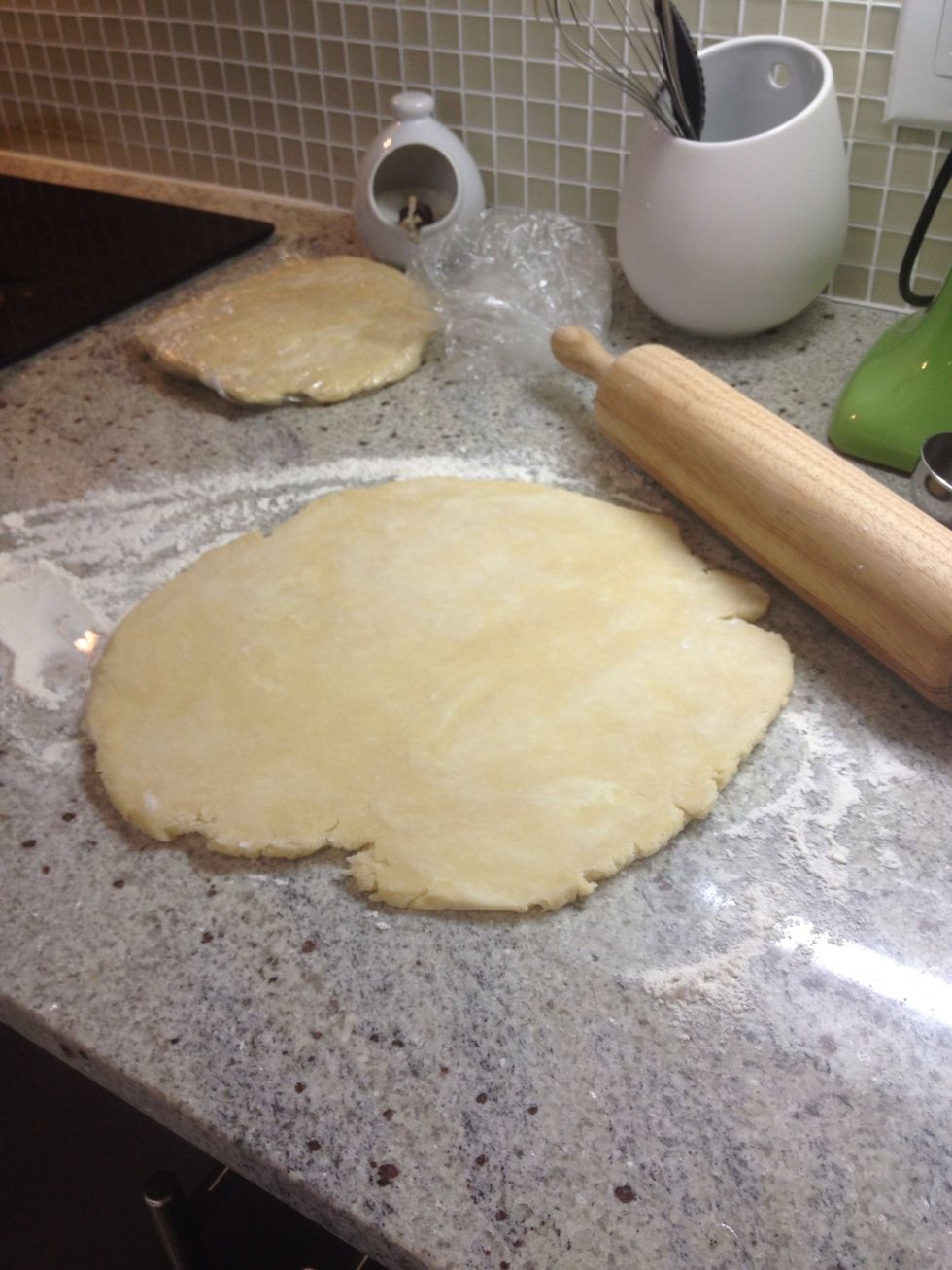 Roll out the larger disc so that it's even and just about 1/4" thick. Try to roll it out so that you have excess hanging over the edge of your pie dish. (I use a bit of flour on the surface too)