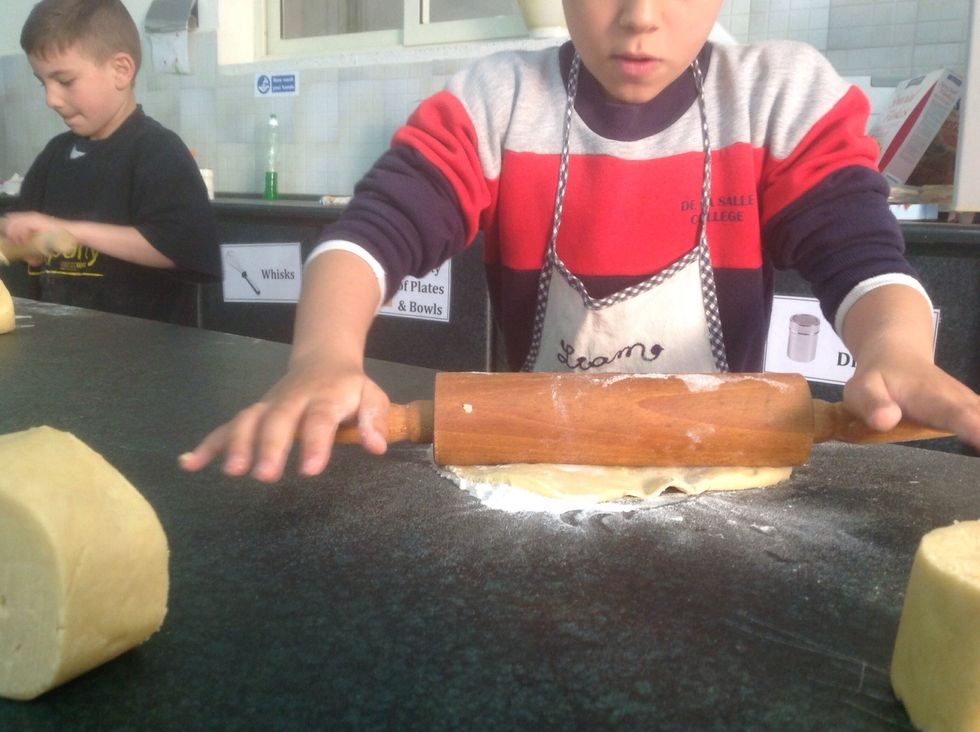 Roll out the pastry using a rolling pin.