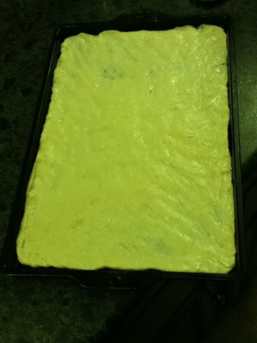 Roll out the pizza crust on a pan.