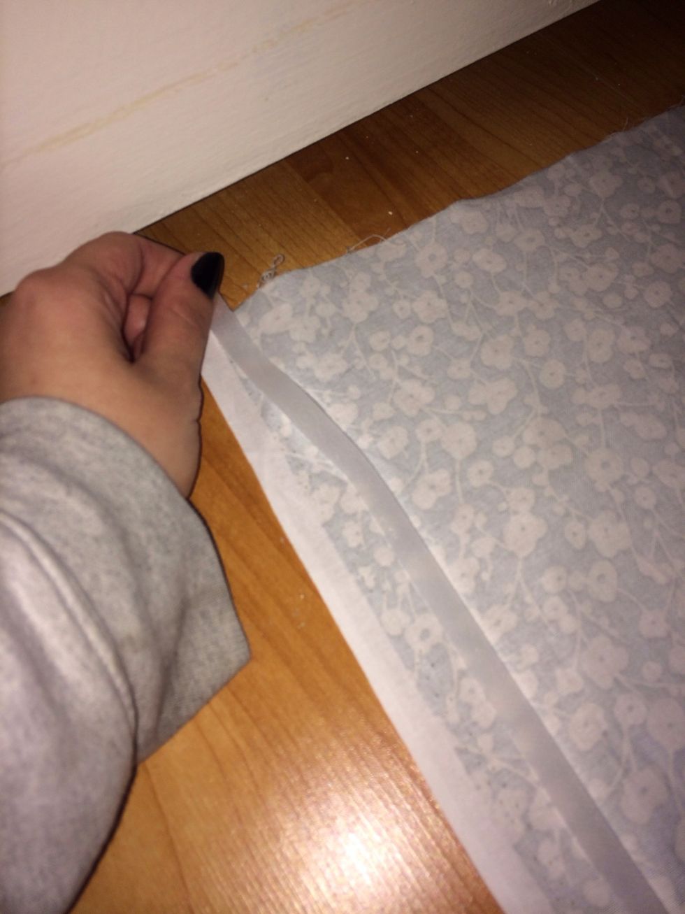 Roll out the tape down one side length wise. It is not naturally sticky so just place on fabric.