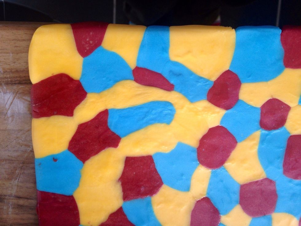 Roll over with your rolling pin until the balls of fondant come together and cover the whole board