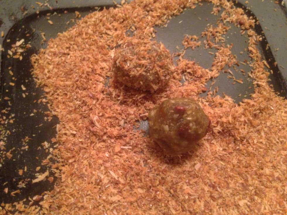 Roll peanut butter mixture into 1/2 inch size balls. Will make 24 total. Roll each bite in the toasted coconut-flax seed mixture as you form each into balls.