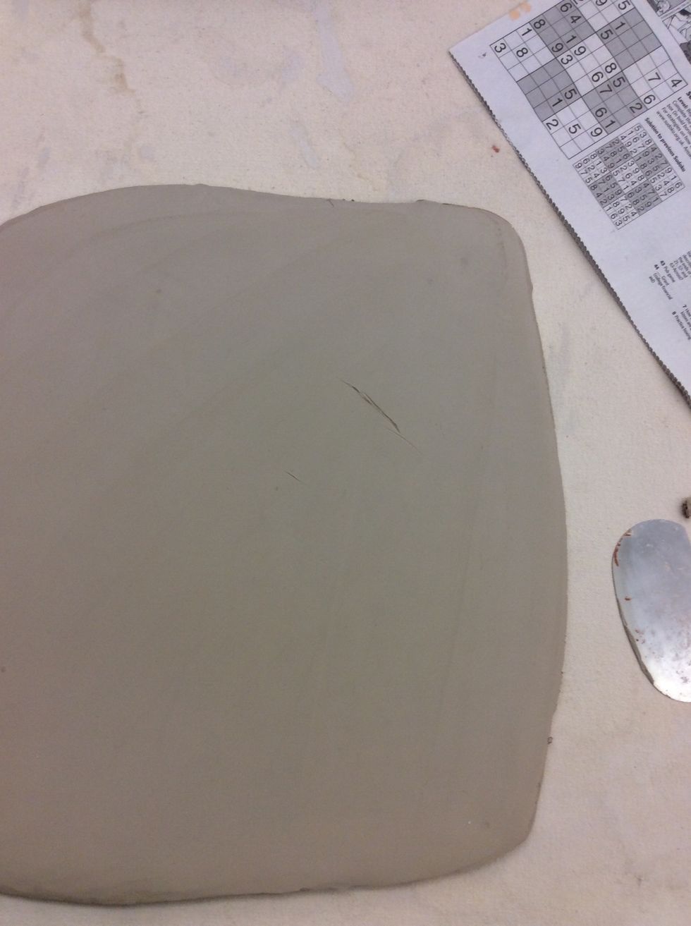 Roll slabs 1/4" thick. Smooth with metal rib.