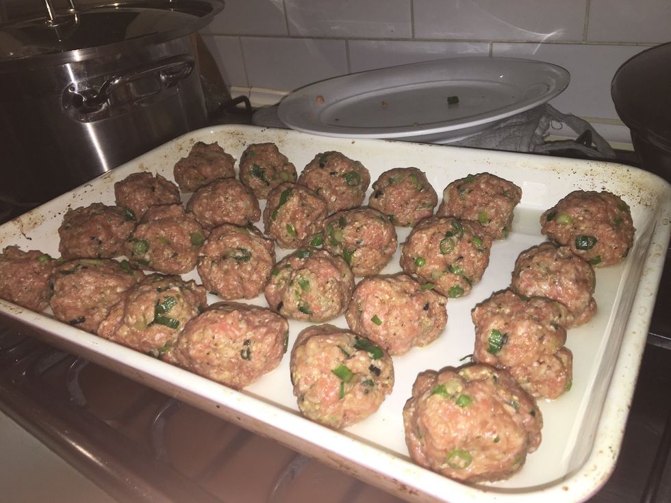 Roll tablespoonfuls of the pork mixture into balls and set aside. Pour the oil into the hot tray, add the meatballs and cook for 5 minutes.