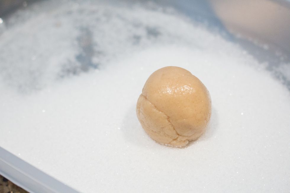 Roll the ball in granulated sugar.