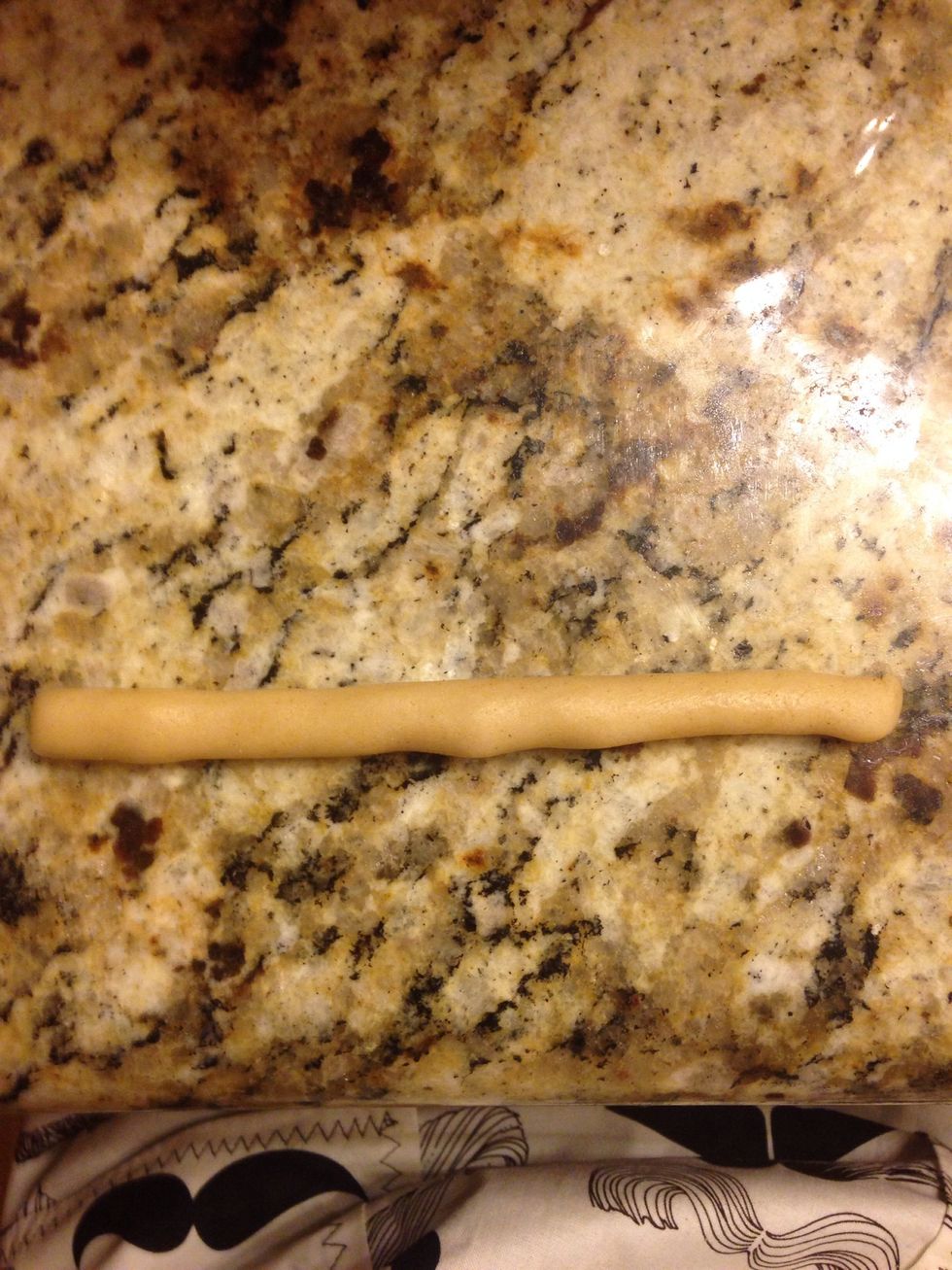 Roll the ball into a rope, it's about 5 inches long.