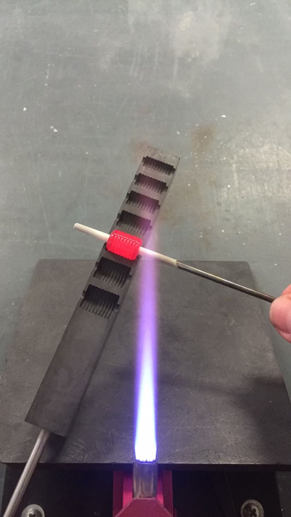 Roll the bead gently in the Beadroller.  It takes a bit of practice to estimate the correct amount of glass for the mold size.  If it gets messed up, reheat and try again.