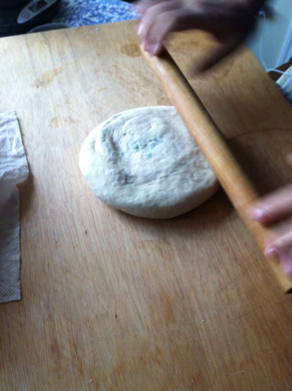 Roll the bun into an approximately 12 in wide, 1/2 in thick pie.