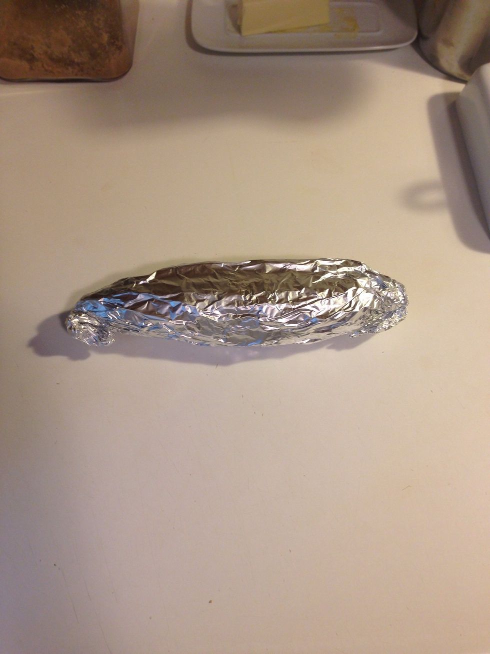 Roll the corn up in the foil, twist the ends, and then fold the ends underneath. Try to get it tight, but not SUPER tight. You don't want to break the foil by wrapping too tightly.