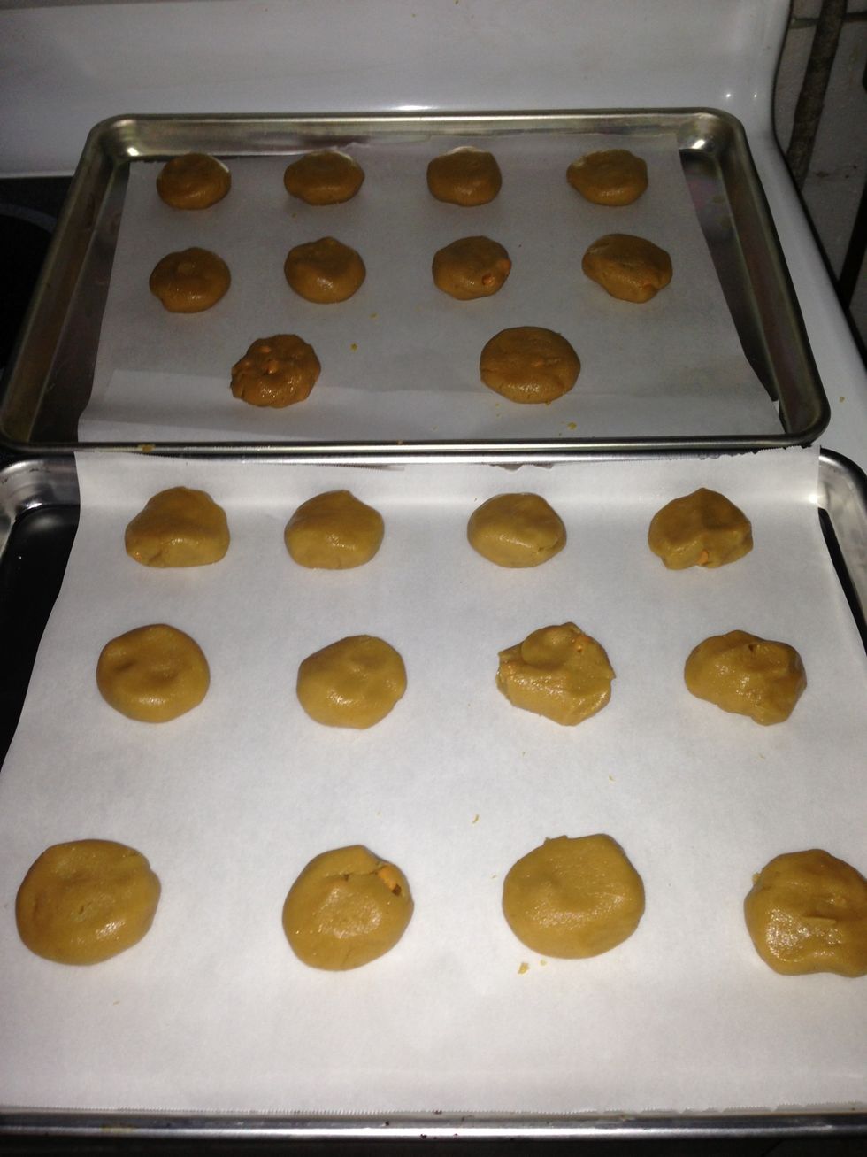 Roll the dough and chips around in your hand and then flatten slightly. Not too much just a bit. Lay them out on a cookie sheet lined with parchment paper. I love parchment paper.