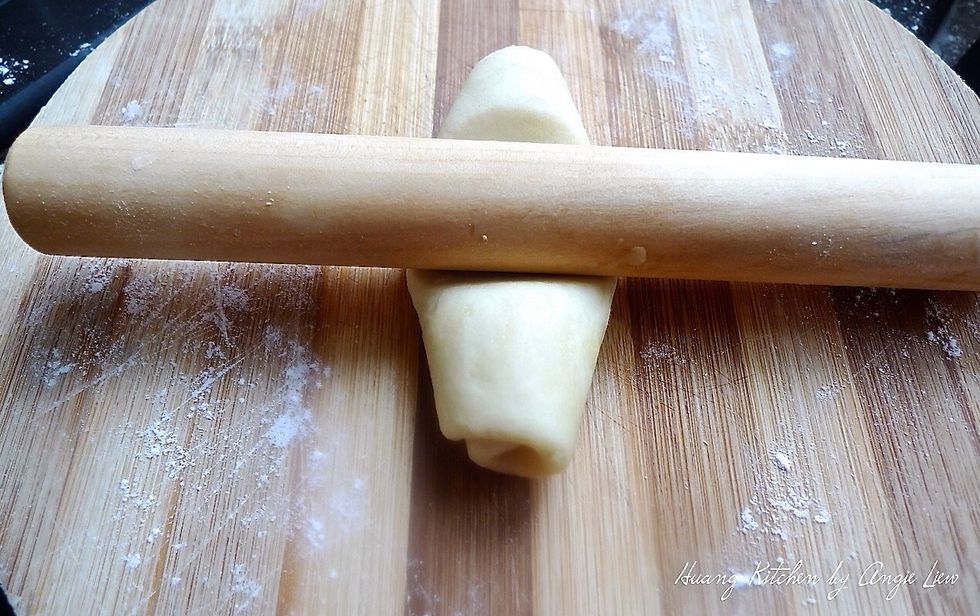 Roll the dough flat again for the SECOND time with a rolling pin.