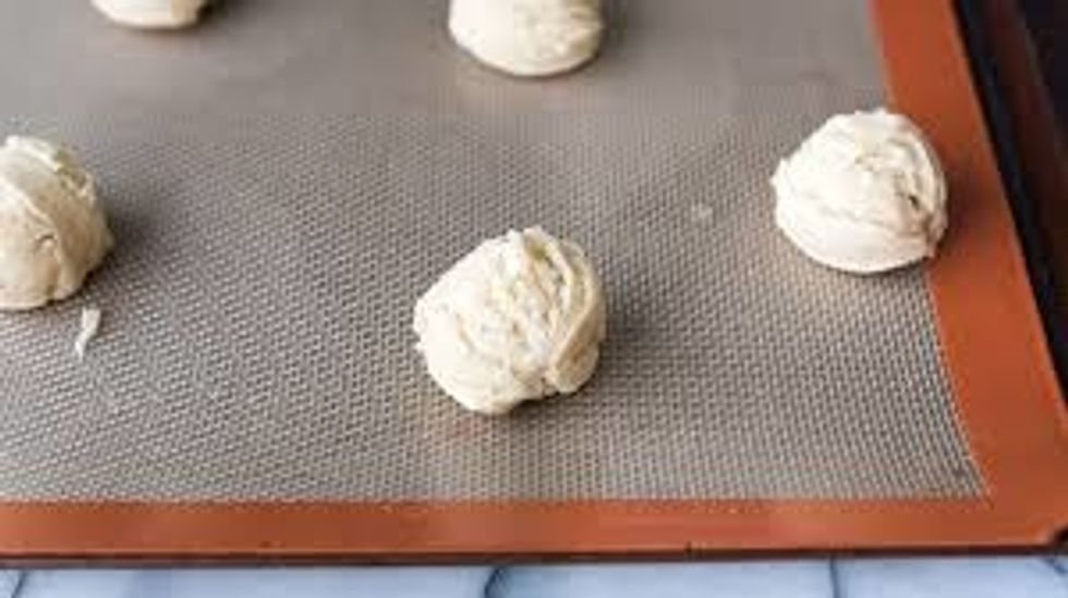 Roll the dough into little balls and place them on the pan so they are spread out.