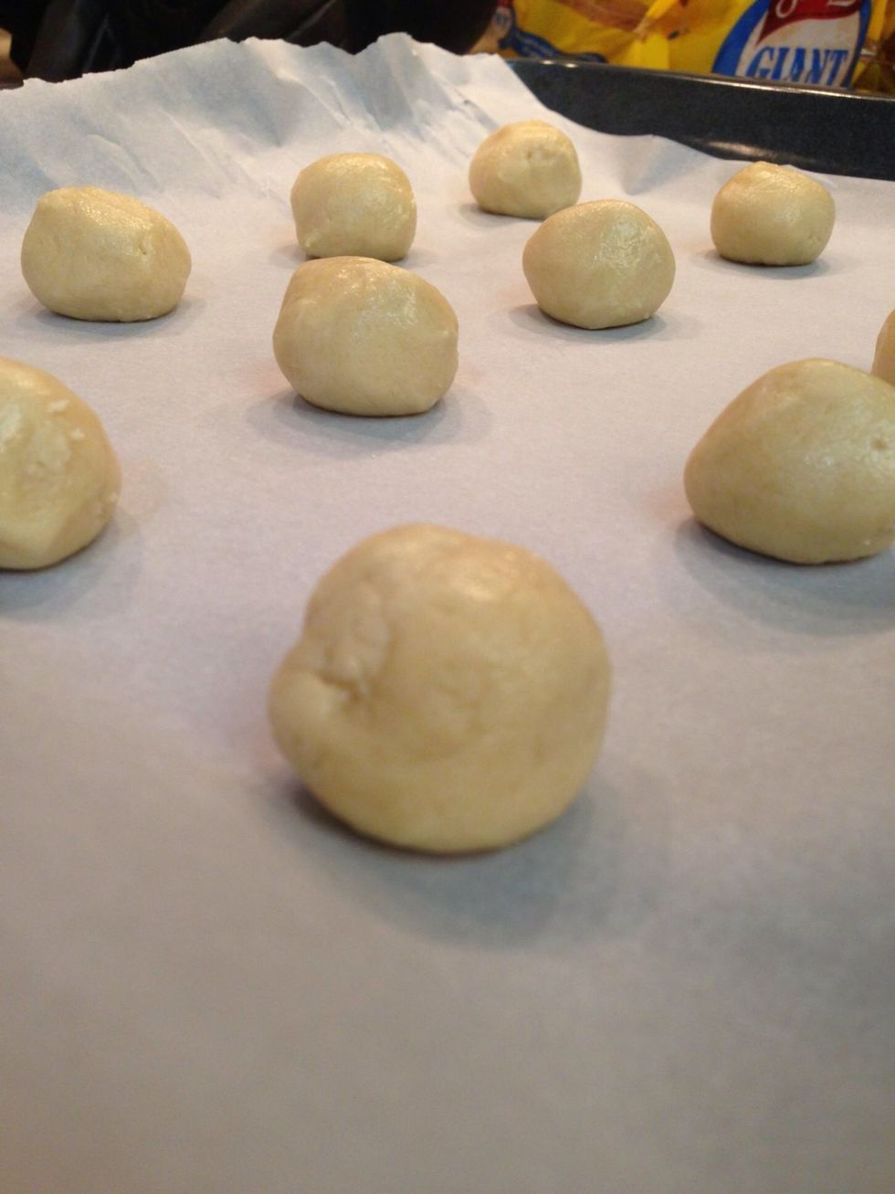 Roll the dough into tablespoon-sized balls and place on a parchment-lined baking sheet. Leave one inch in between the cookies for spreading.