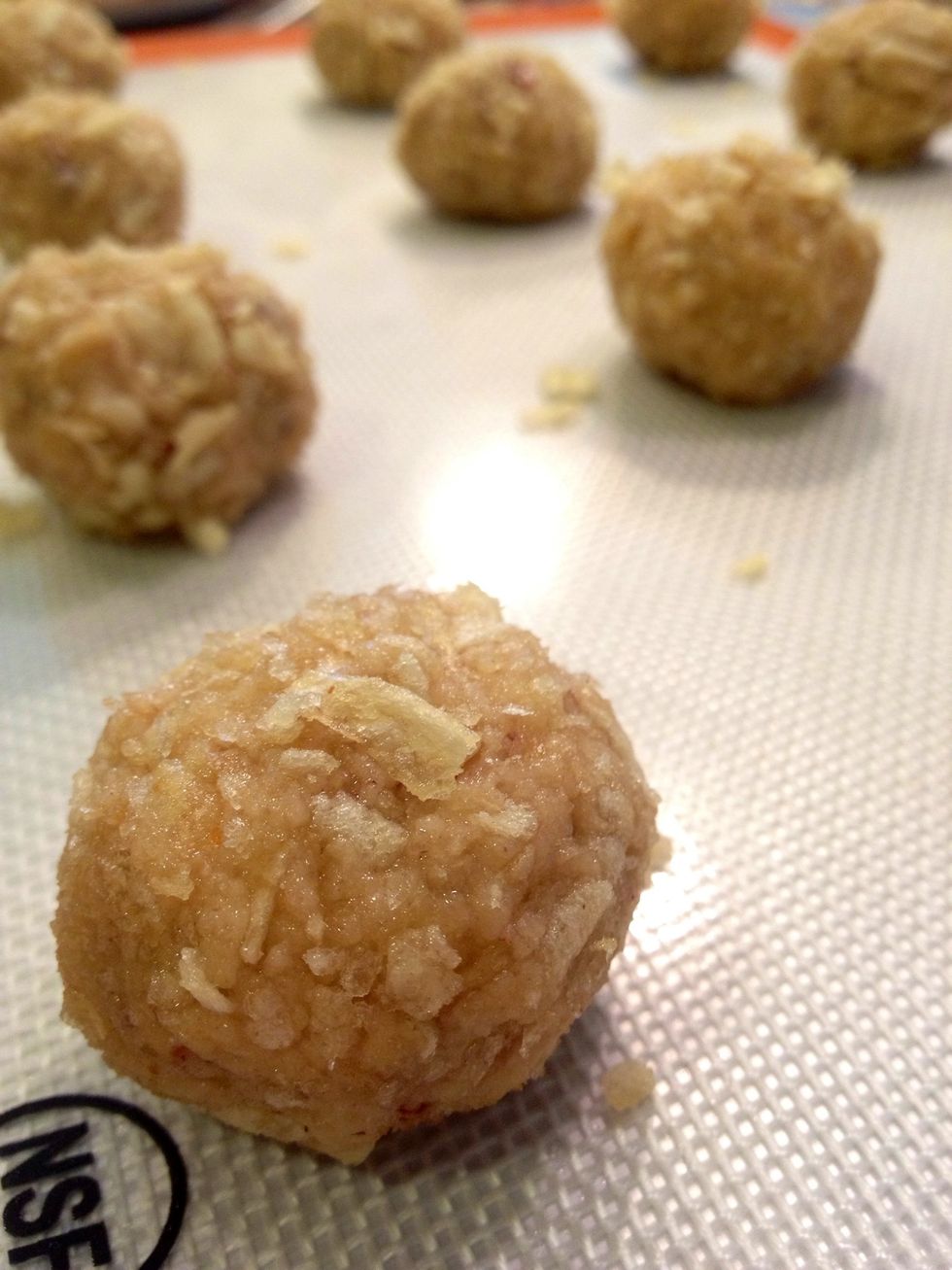 Roll the dough into two inch balls. Coat the cookies in the crushed potato chips. Place them on a lined baking sheet spaced two inches apart.