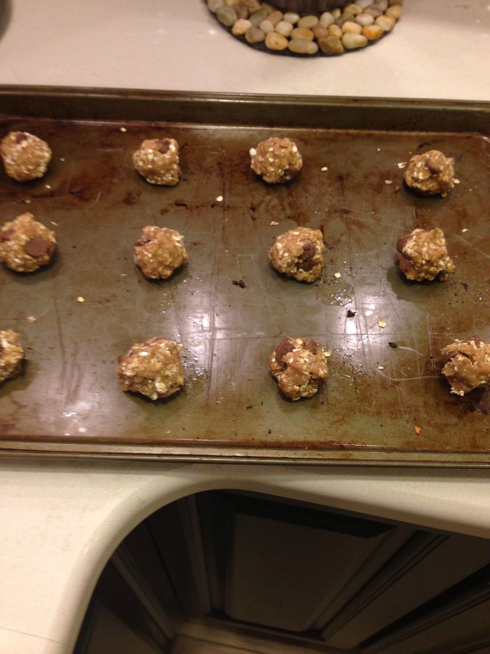 roll the dough into walnut sized balls and place two inches apart on cookie sheets