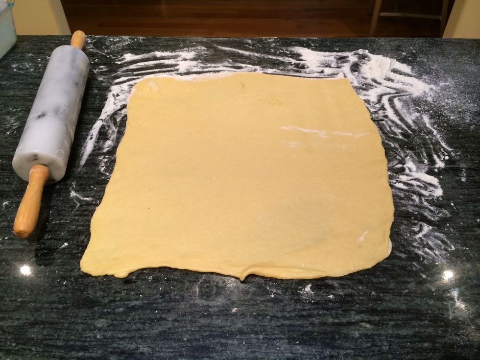 Roll the dough out into a 16 inch square so that it is 1/8 inch thick.