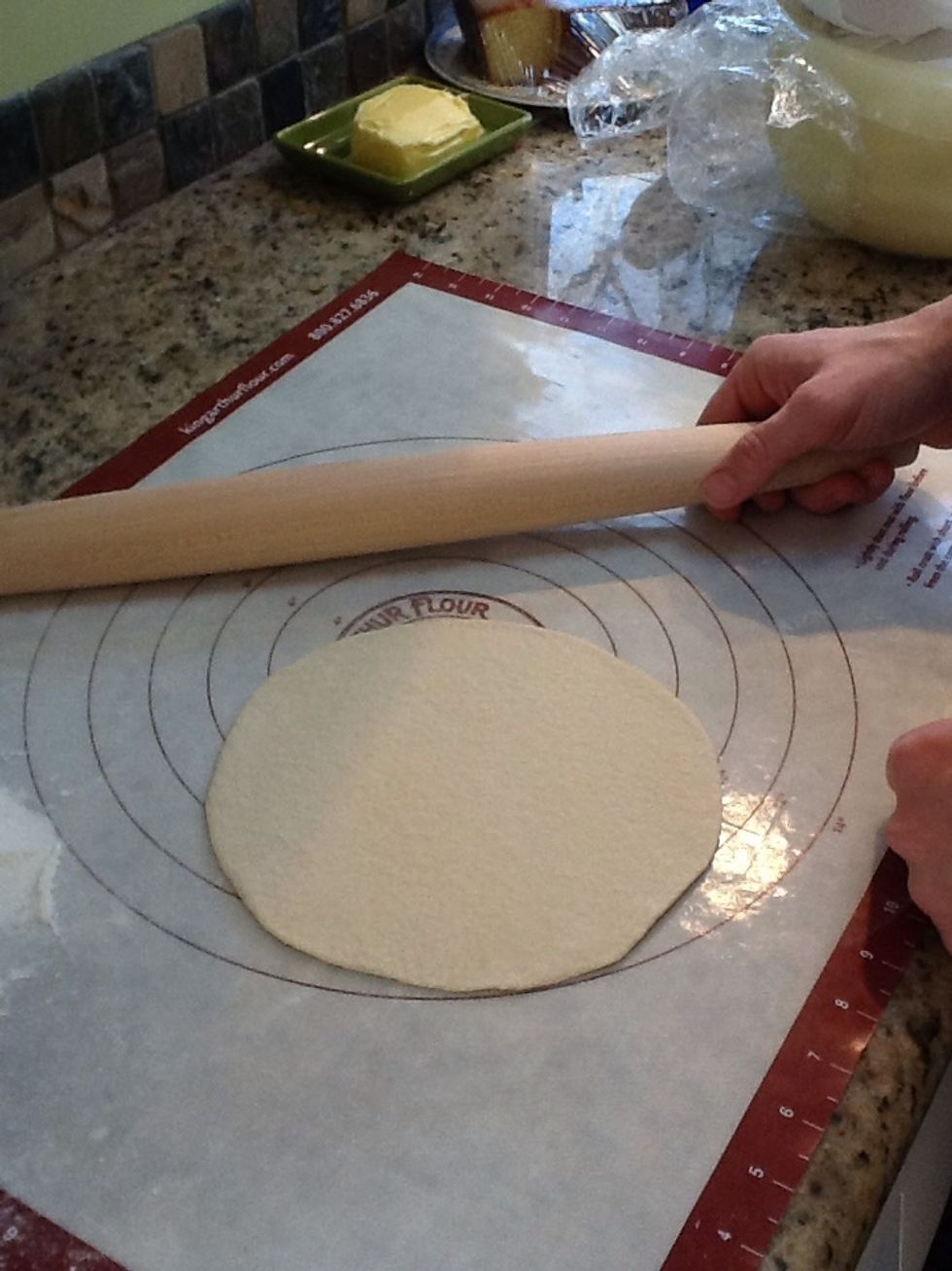 Roll the flattened balls with a little flour into very thin and even circles
