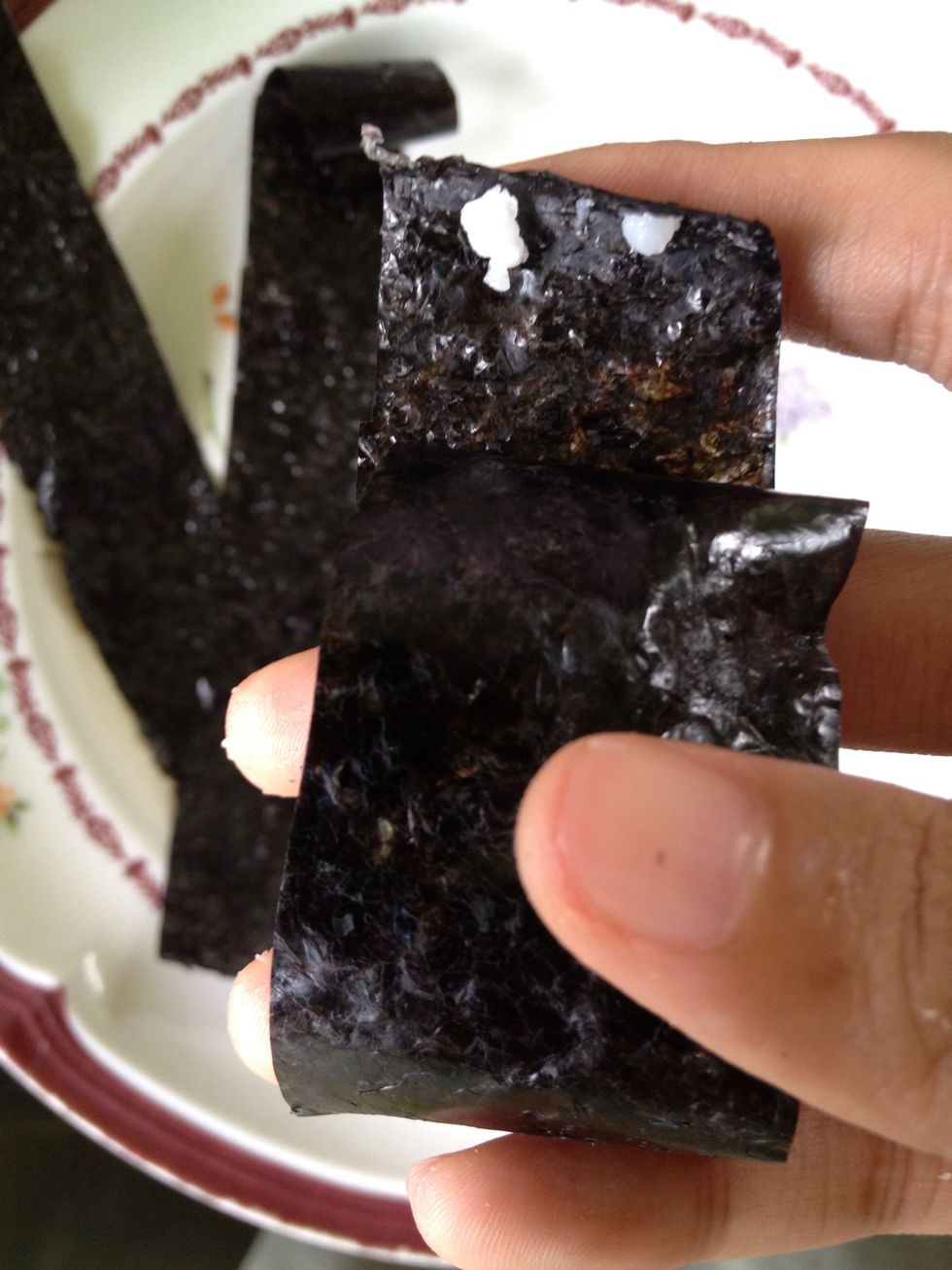 Roll the nori around the rice balls and use a lil bit of rice to stick the end. Put it aside