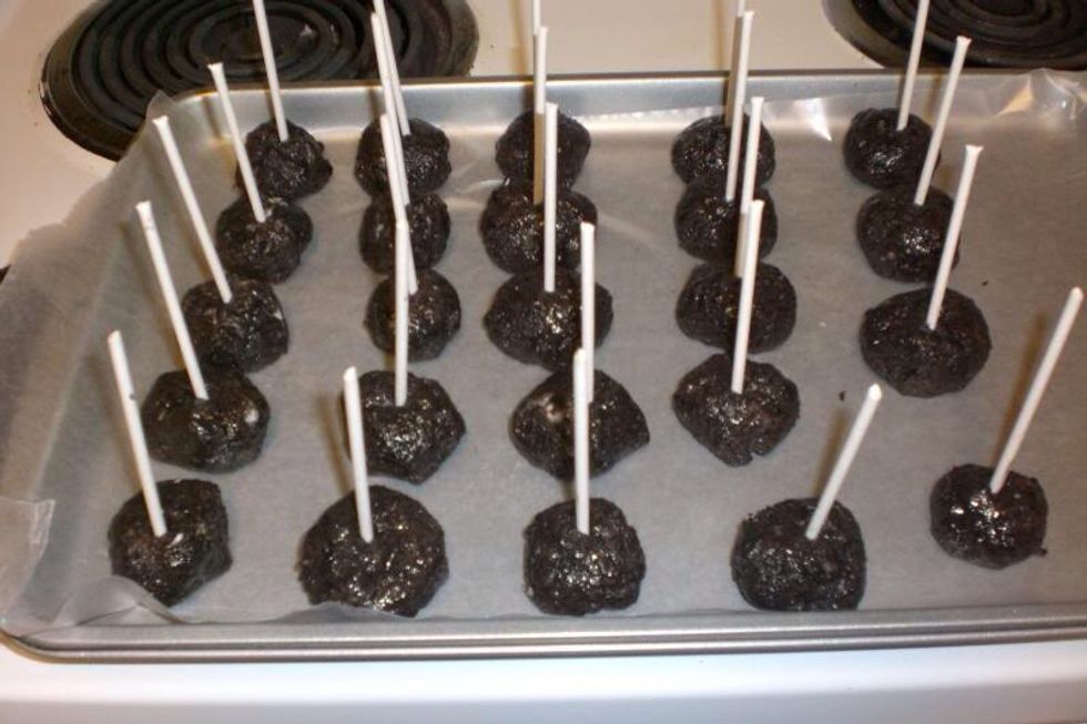 Roll the Oreo mix into small balls, place a sucker stick in the middle and put them on a pan.