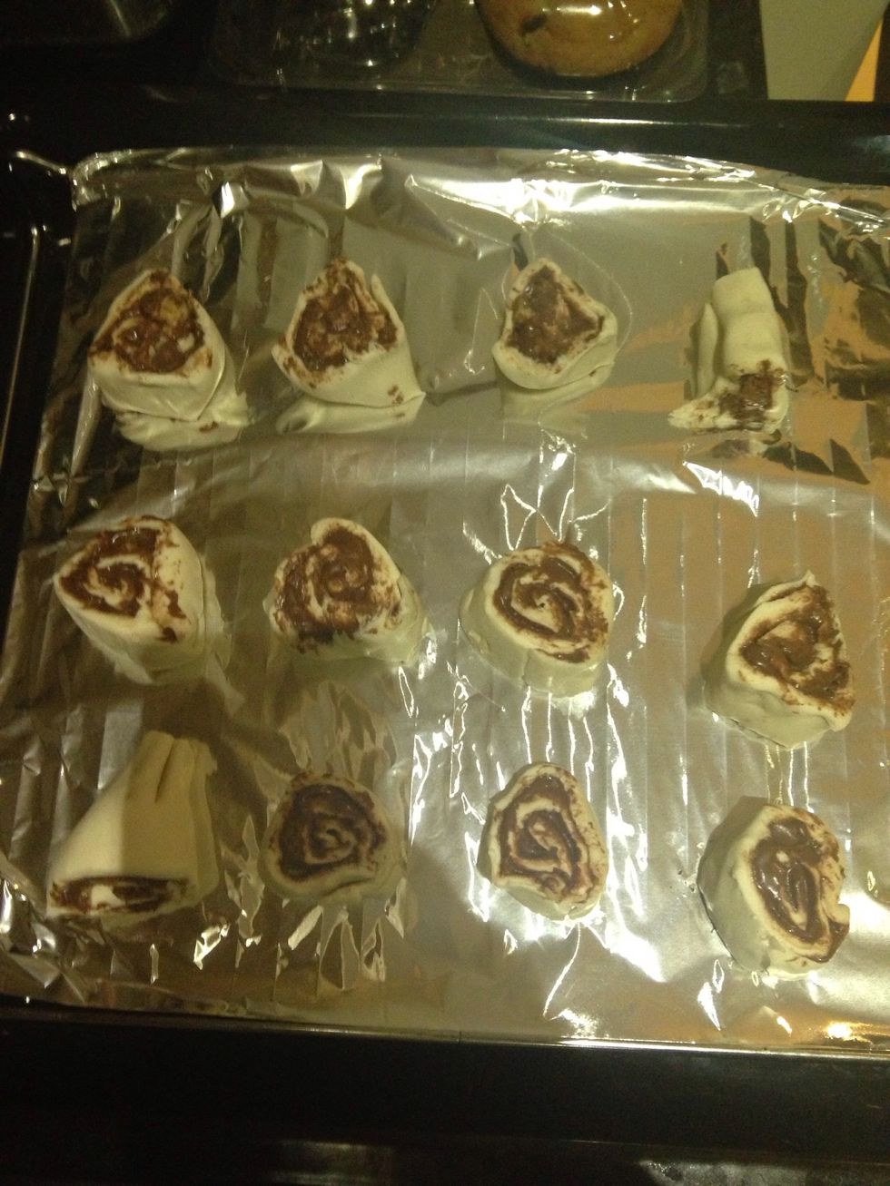 Roll the puff pastry into a tight log and then cut into pieces to form this swirl shape. Try not to distort the shape too much.