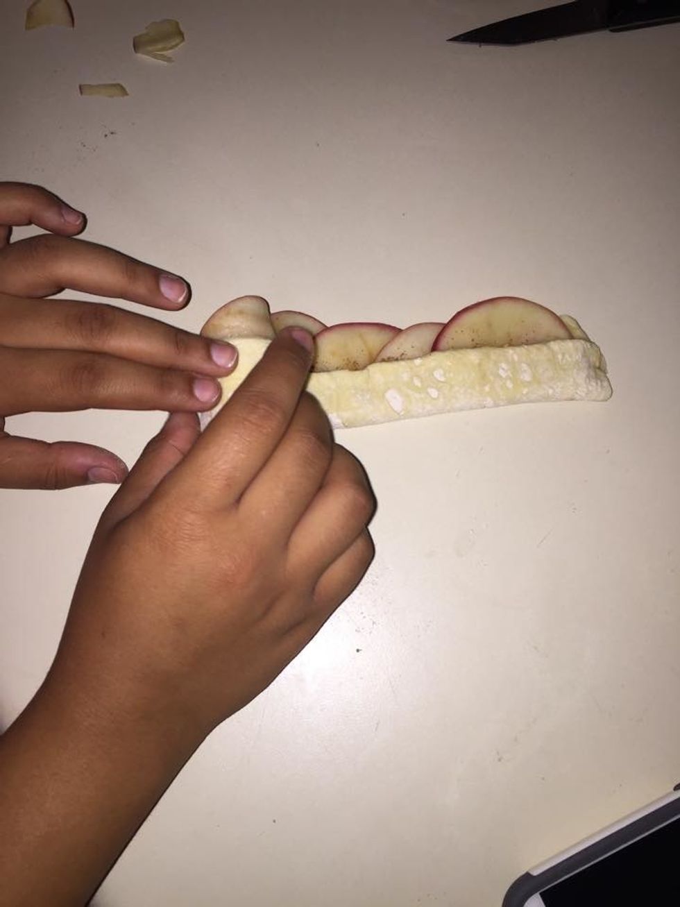 Roll the puff pastry strips.