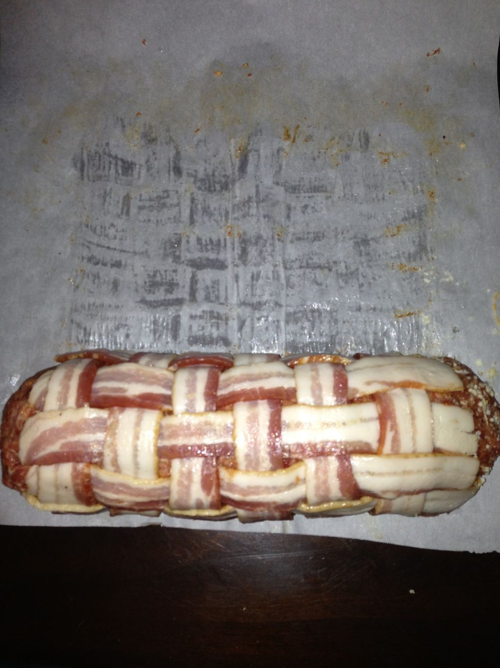 Roll the sausage back toward you, wrapping the weave around it tightly.  At this point you can roll it into the parchment paper to store it overnight if you aren't going to smoke it right away.