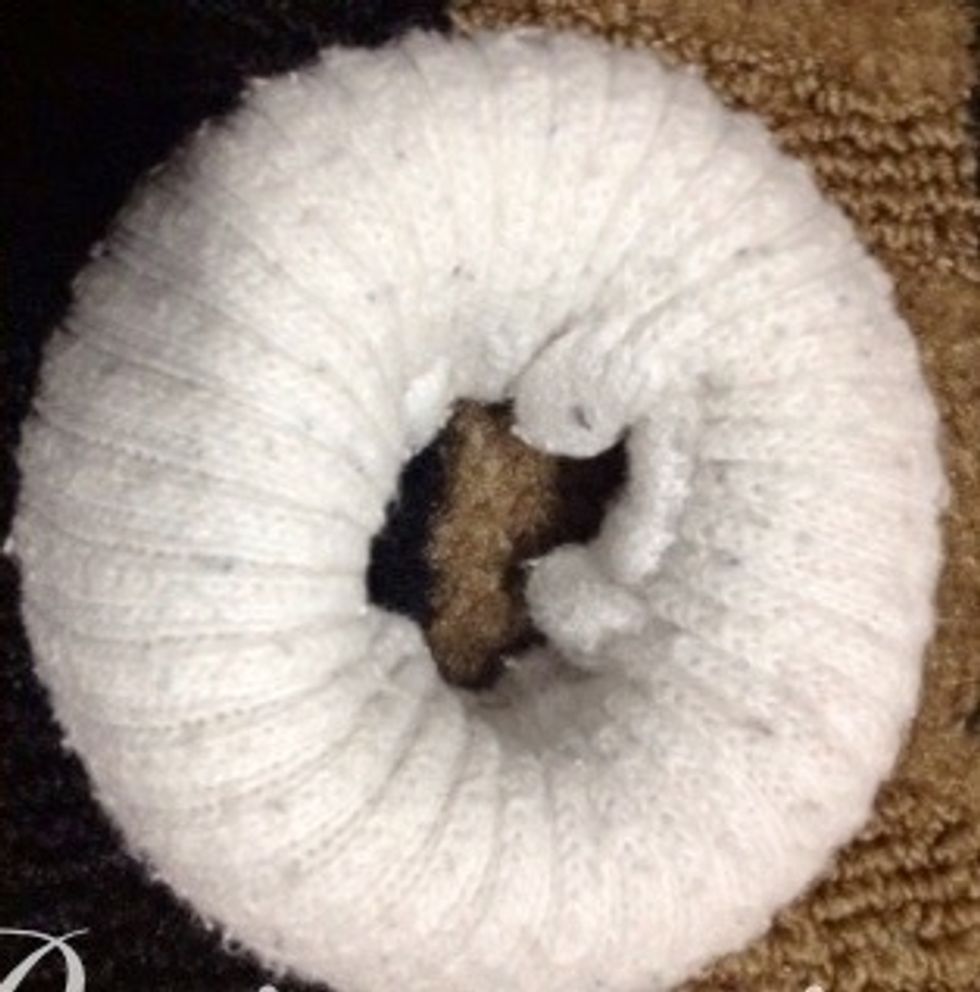 Roll the sock into a donut.