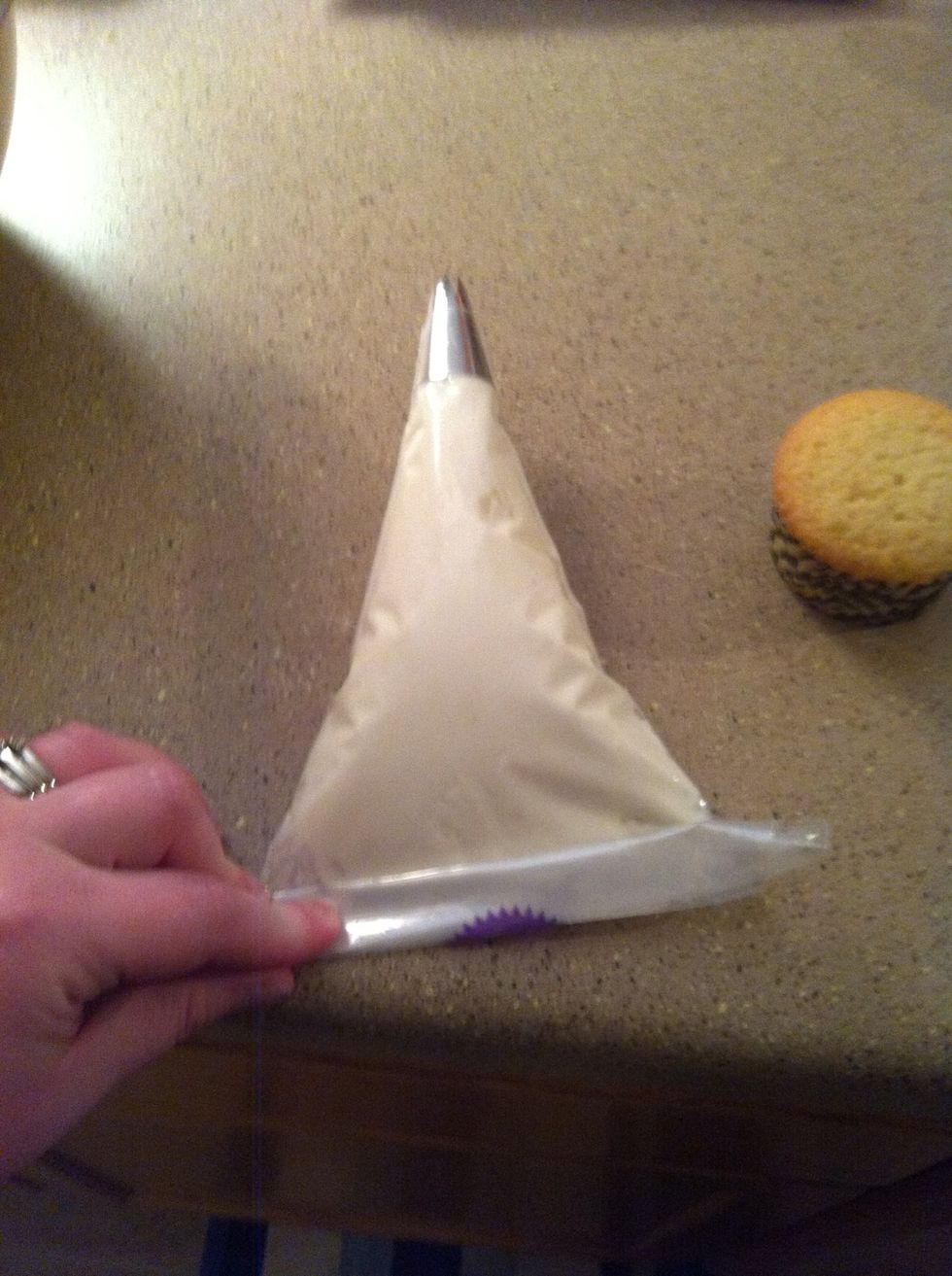 Roll the top of the bag to close. Some people twist it, but I find it easier to hold the bag when it's rolled. And most times when it's twisted, the icing still comes out the top.