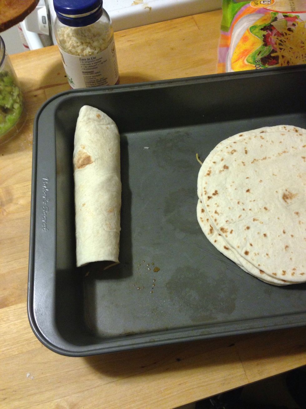 Roll the tortilla up and put in the pan. Repeat until you run out of chicken. I used half flour and half corn tortillas.