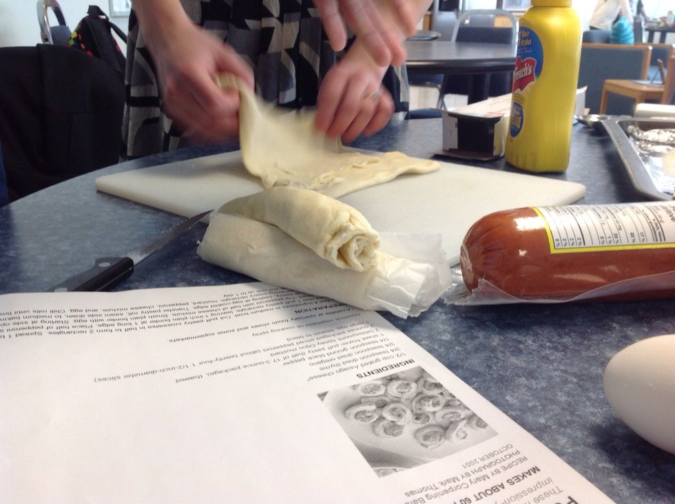 Roll up pastry sealing with egg