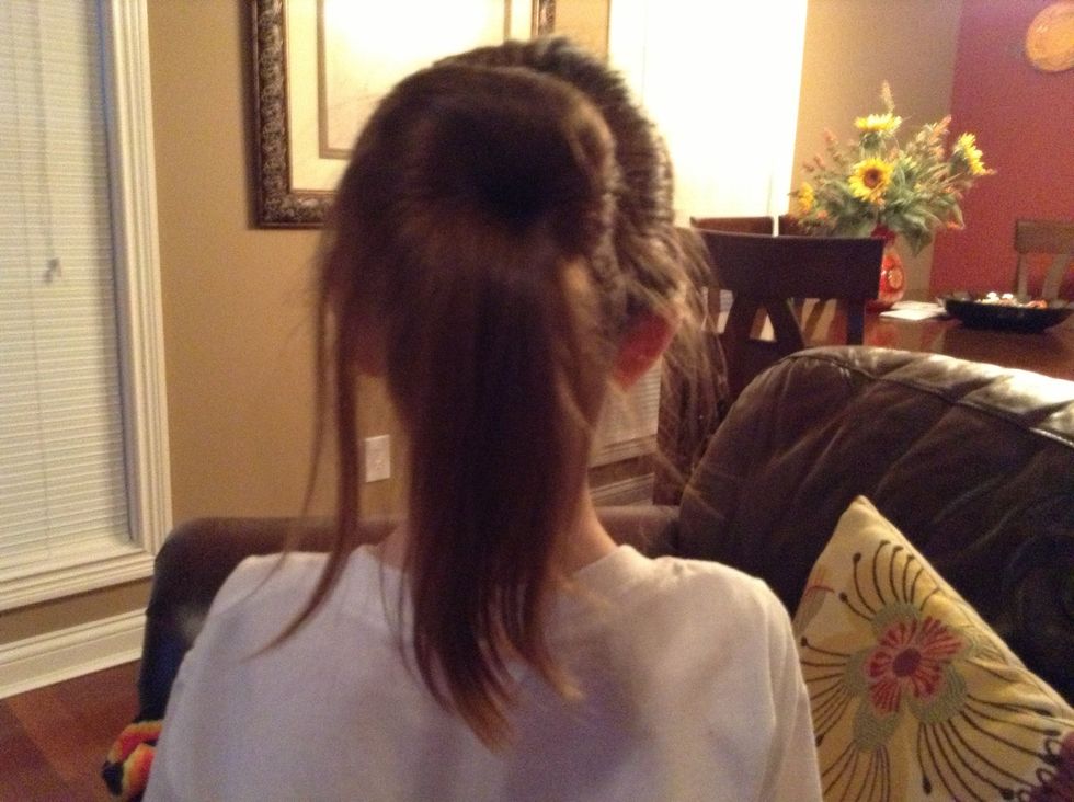 Roll up sock and hair. There will be hair left over but you can use a ponytail to pull the hair into the bun