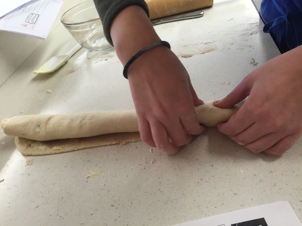 Roll up tightly, starting with the long side. Seal by pinching the dough with your fingers