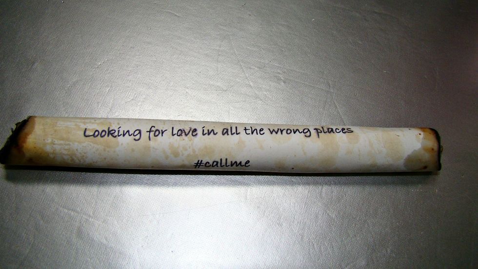 Roll your message to fit in bottle and burn the edges.