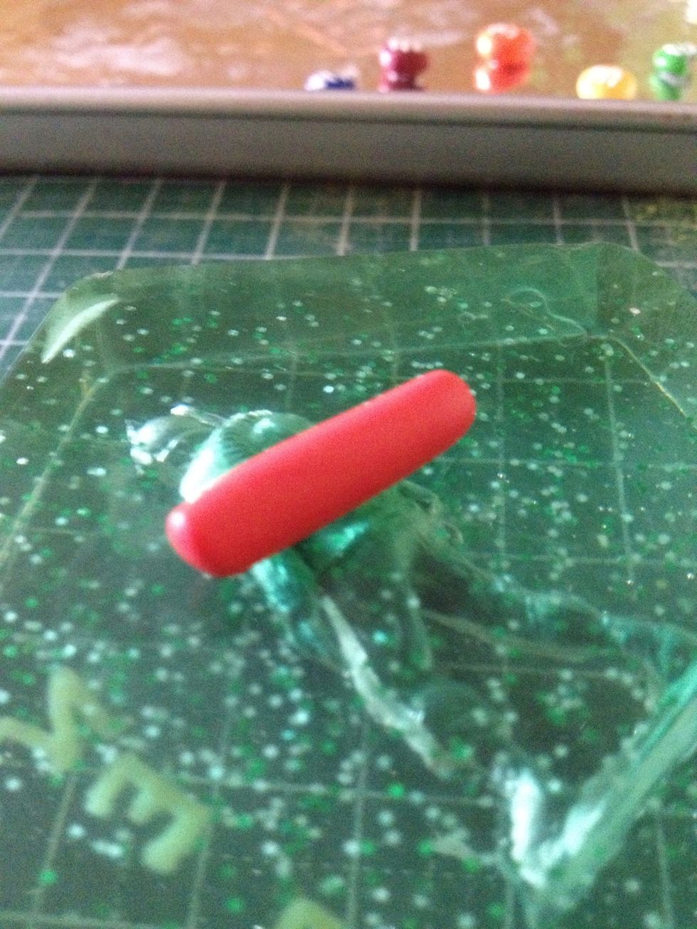 Roll your red clay into a thick cylinder.