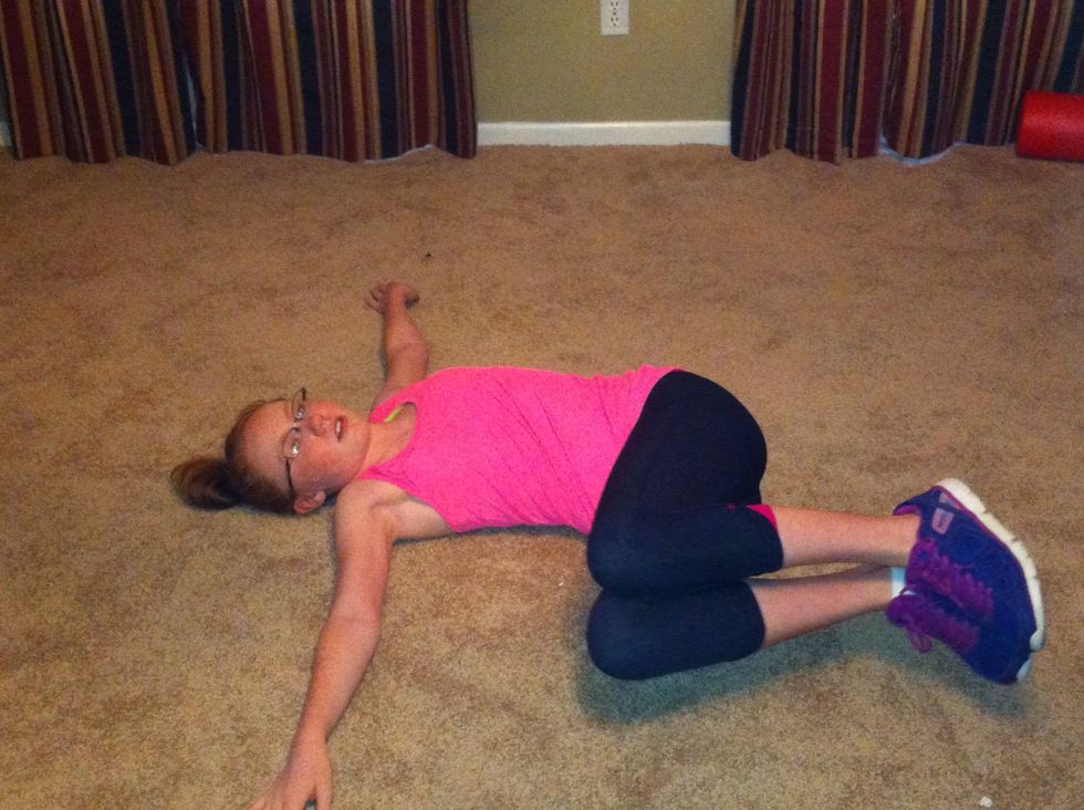 Rotate legs to one side slowly without touching the floor. Raise to center and hold for 2 counts.