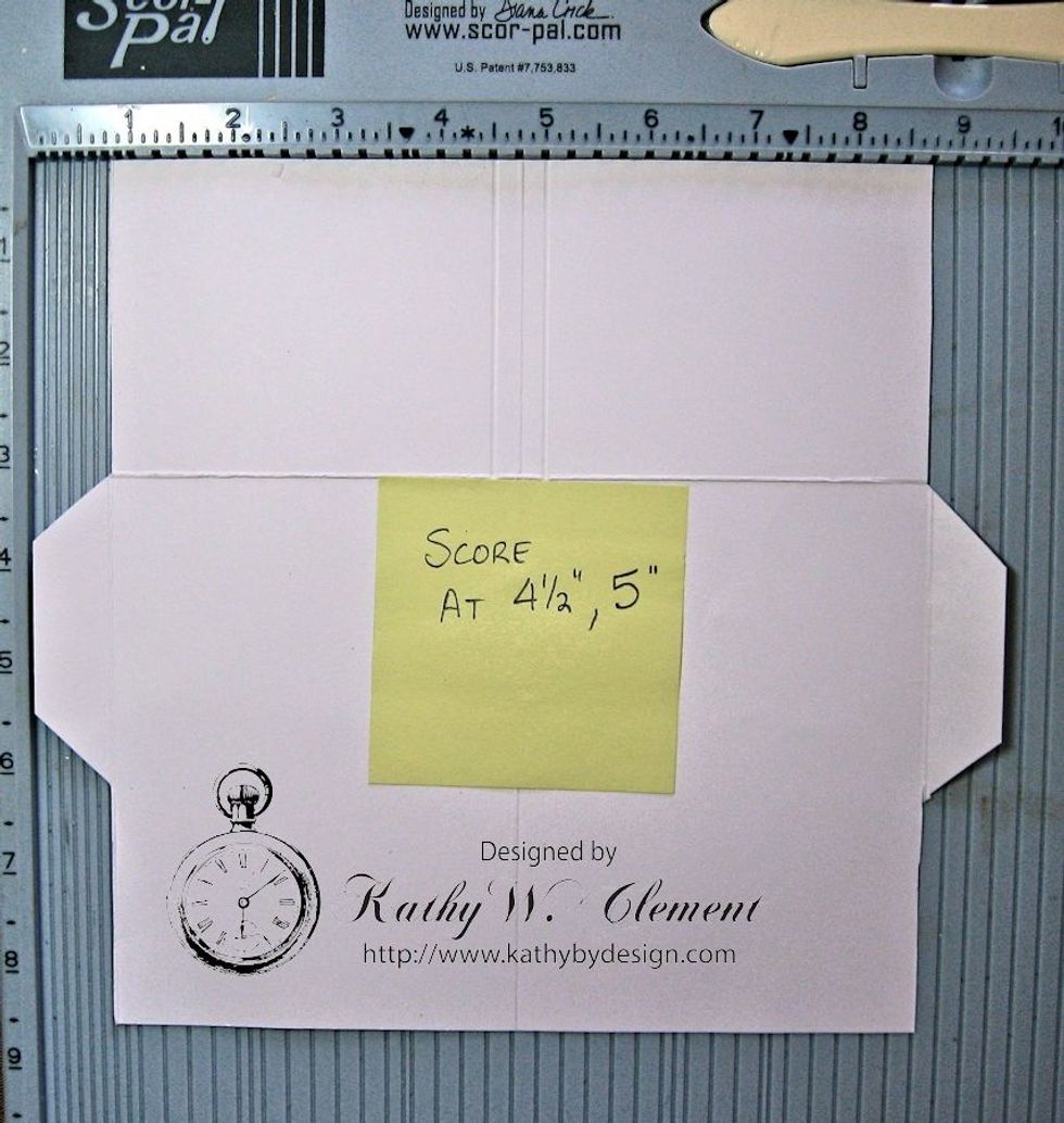 Rotate the cardstock so that the bottom edge is at the top and the left side is lined up with the left hand rail. Score at 4.5" and again at 5 from the top edge to the horizontal score line ".
