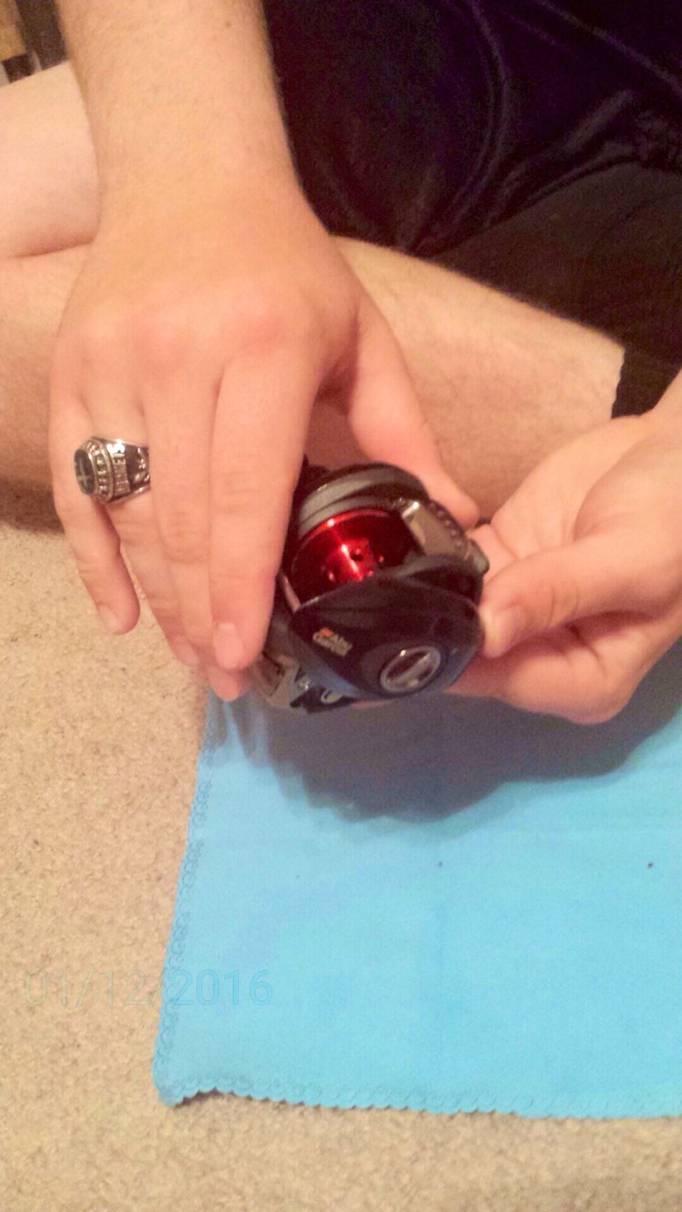 Rotate the cover opposite of the handle downwards.