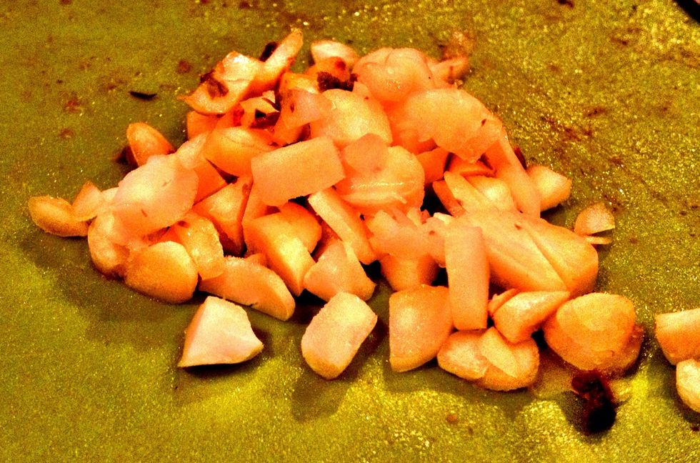 Rough chop 4 cloves of garlic. Drop it right into the hot grease from the salt pork. It's a mix between a sweat & a fry. Who am I kidding? It's garlic, fried in bacon grease. Take a moment w/ that.