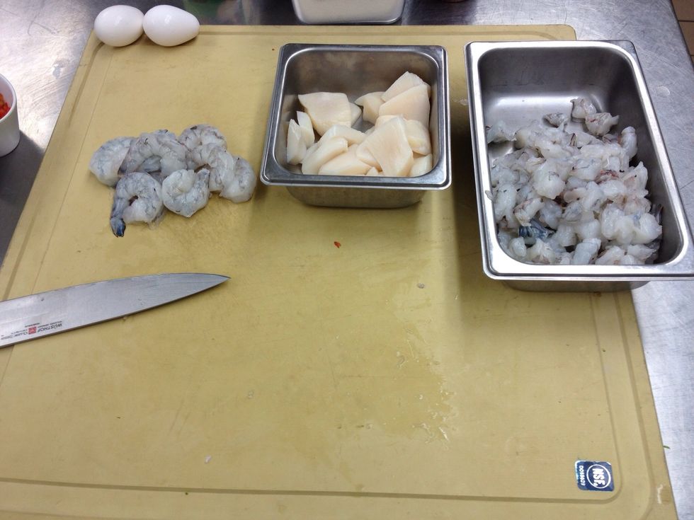 Rough chop scallops and shrimp (remove tails). Combine scallops and all but 1/4 of chopped shrimp in food processor. Add eggs, heavy cream, green onion, salt, and pepper. Process until smooth.